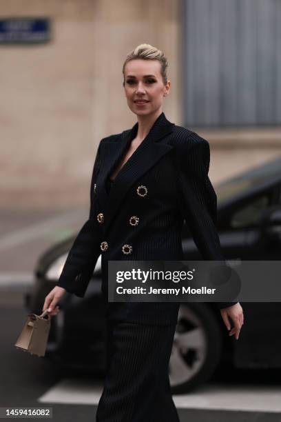 Marina von Lison seen wearing Hermes mini Kelly beige leather bag and Nicolas Besson matching suit before Alexandre Vauthier show during Paris...