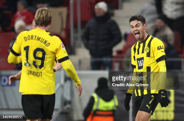 Giovanni Reyna of Borussia Dortmund celebrates with team mate Julian Brandt after scoring their sides second goal during the Bundesliga match between...
