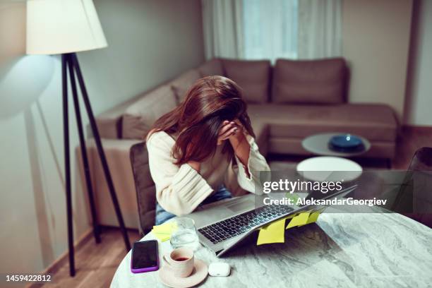 female feeling stressed out and trying to reach school paper deadline in time - woman smiling facing down stock pictures, royalty-free photos & images