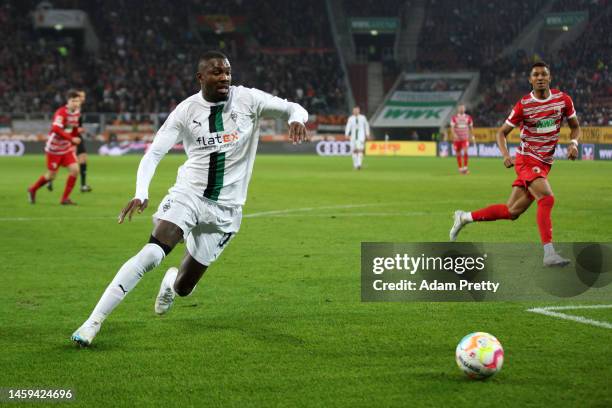 Marcus Thuram of Borussia Monchengladbach runs with the ball during the Bundesliga match between FC Augsburg and Borussia Mönchengladbach at...