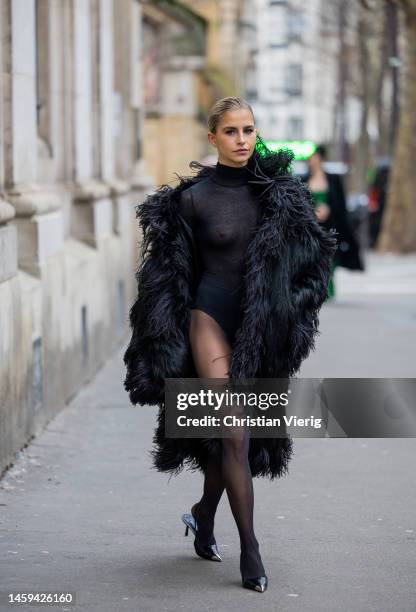 Caroline Caro Daur wears black see trough turtleneck body, tights, pointed heels, fur coat outside Elie Saab during Paris Fashion Week - Haute...