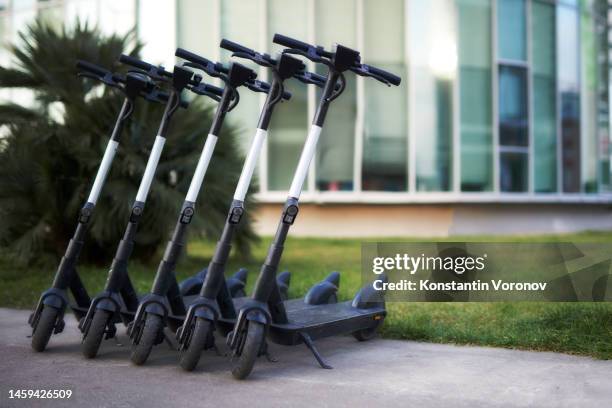 electric push scooters parked in the city - sharing economy 個照片及圖片檔