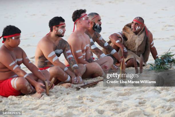 First Nations Elder Dean Kelly and Yuin Gurandgi dancers sit on the sand following a Dawn Reflection and Smoking Ceremony at Bondi Beach on January...
