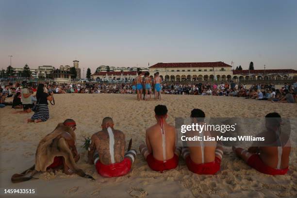 First Nations Elder Dean Kelly and Yuin Gurandgi dancers look on as Gamay Dancers perform during a Dawn Reflection and Smoking Ceremony at Bondi...