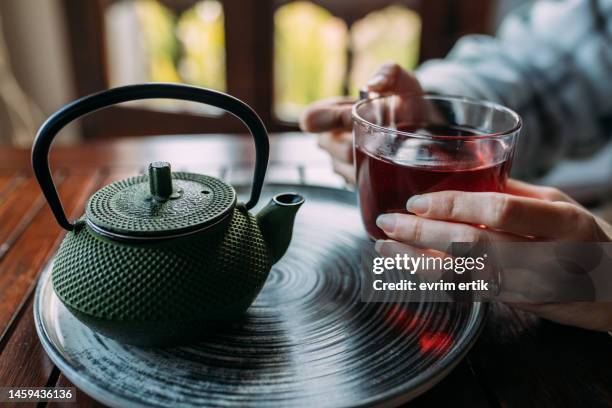 woman drinking herbal tea on cold winter day - black tea stock pictures, royalty-free photos & images