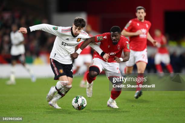 Alejandro Garnacho of Manchester United is challenged by Serge Aurier of Nottingham Forest during the Carabao Cup Semi Final 1st Leg match between...