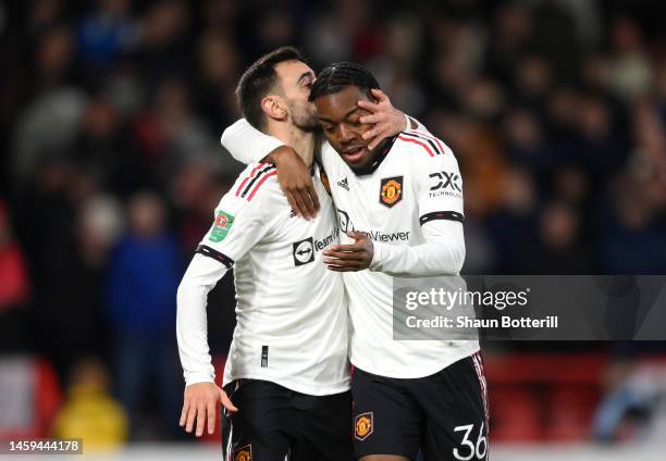 Bruno Fernandes celebrates with Anthony Elanga of Manchester United after scoring the team's third goal during the Carabao Cup Semi Final 1st Leg...