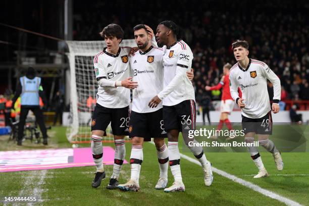 Bruno Fernandes celebrates with Facundo Pellistri and Anthony Elanga of Manchester United after scoring the team's third goal during the Carabao Cup...