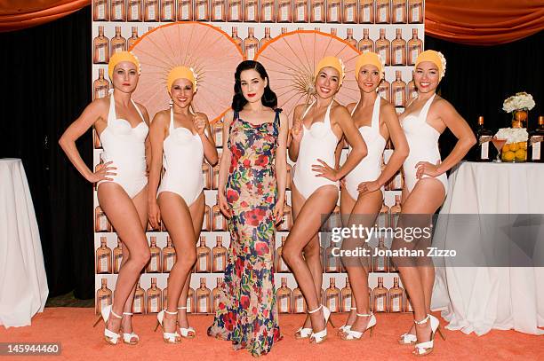 Dita Von Teese and the Aqualillies pose at the Cointreau and Dita Von Teese Launch Summer Bar Cart Cocktail Program at Poolside Soiree on June 7,...