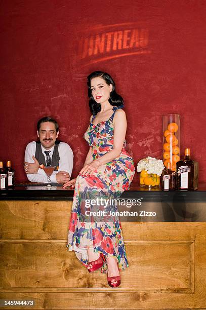 Kyle Ford and Dita Von Teese pose at the Cointreau and Dita Von Teese Launch Summer Bar Cart Cocktail Program at Poolside Soiree on June 7, 2012 at...