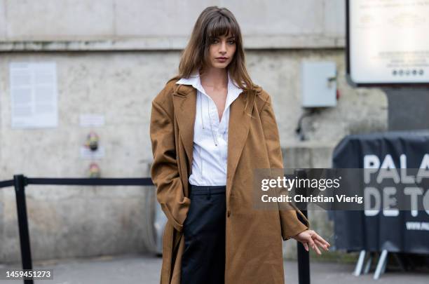 Mara Lafontan wears brown coat, white blouse, black pants, heels outside Ashi Studio during Paris Fashion Week - Haute Couture Spring Summer : Day...