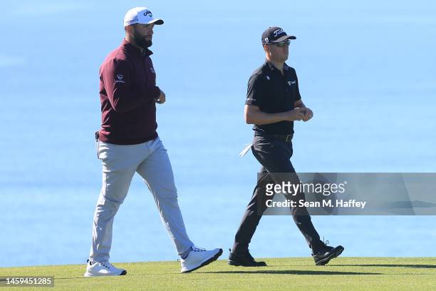 Jon Rahm and Justin Thomas walk up the fairway on the th hole of the South Course during the first round of the Farmers Insurance Open at Torrey...