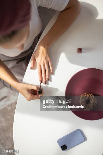 woman applying nail polish - gel effect stock pictures, royalty-free photos & images