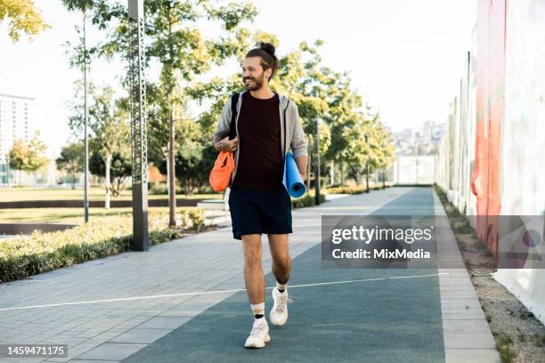 happy young man going to exercise outdoors - gymtas stockfoto's en -beelden