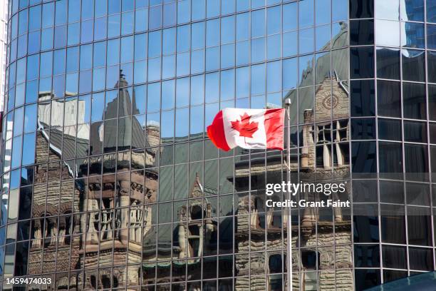 canadian flag and building reflections. - ontario canada flag stock pictures, royalty-free photos & images