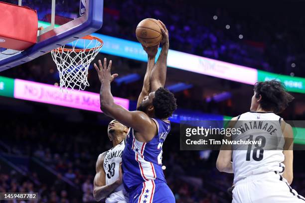 Nic Claxton of the Brooklyn Nets blocks Joel Embiid of the Philadelphia 76ers during the first quarter at Wells Fargo Center on January 25, 2023 in...