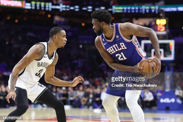Nic Claxton of the Brooklyn Nets guards Joel Embiid of the Philadelphia 76ers during the first quarter at Wells Fargo Center on January 25, 2023 in...