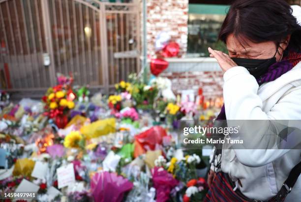 Person reacts while visiting the memorial outside the Star Ballroom Dance Studio where a deadly mass shooting took place on January 25, 2023 in...