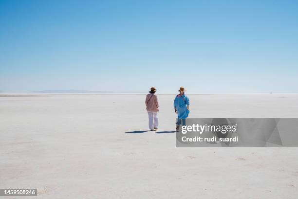 senior tourist walking on white salt in salt lake - traditional clothing stock pictures, royalty-free photos & images