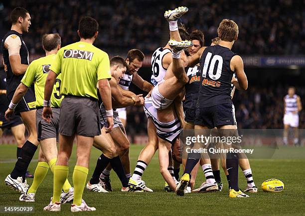 Players wrestle during the round 11 AFL match between the Carlton Blues and the Geelong Cats at Etihad Stadium on June 8, 2012 in Melbourne,...