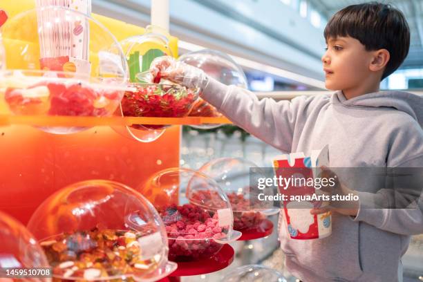 child shopping at candy store - kid candy store stock pictures, royalty-free photos & images