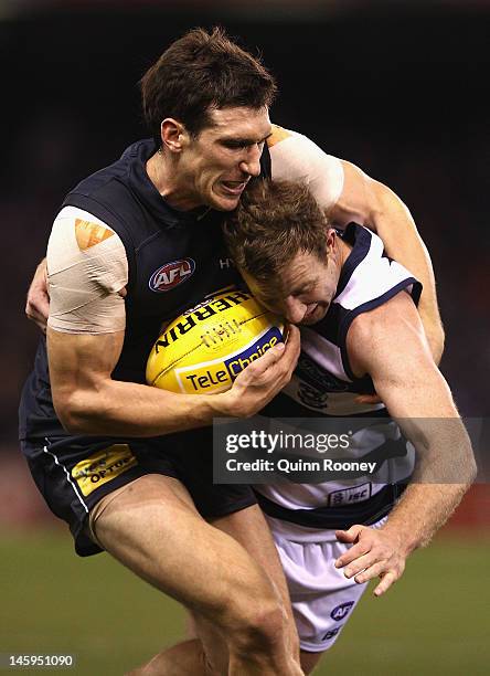 Steve Johnson of the Cats is tackled by Michael Jamison of the Blues during the round 11 AFL match between the Carlton Blues and the Geelong Cats at...