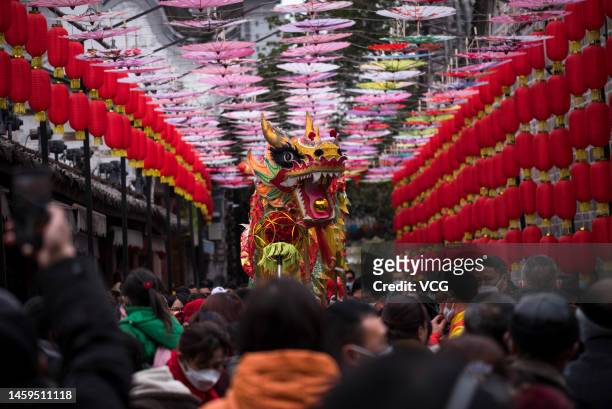 Tourists watch as folk artists perform dragon dance at Luodai ancient town during the Spring Festival holiday on January 23, 2023 in Chengdu, Sichuan...