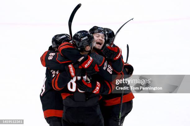 Brett Pesce of the Carolina Hurricanes celebrates with Martin Necas, Seth Jarvis and Brent Burns of the Carolina Hurricanes after the Hurricanes beat...