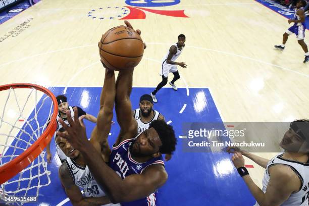 Nic Claxton of the Brooklyn Nets blocks Joel Embiid of the Philadelphia 76ers during the first quarter at Wells Fargo Center on January 25, 2023 in...