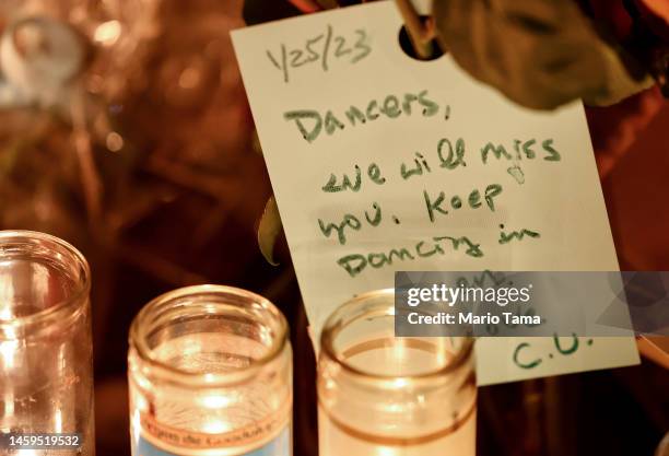 Message to the dancers is viewed at a candlelight vigil at the growing memorial outside the Star Ballroom Dance Studio where a deadly mass shooting...