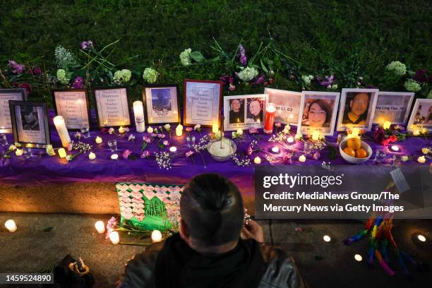 Dr. Cesar Cruz, founder of Homies Empowerment, pays respects as he decorate a makeshift memorial during a candlelight vigil in honor to the mass...