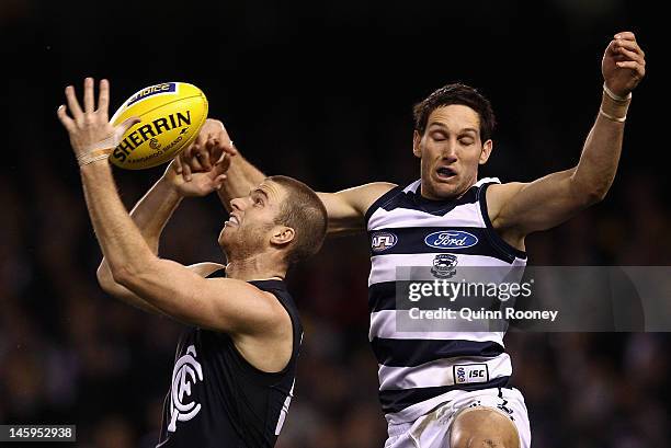 Lachie Henderson of the Blues marks infront of Harry Taylor of the Cats during the round 11 AFL match between the Carlton Blues and the Geelong Cats...