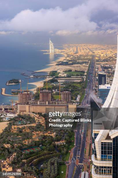 aerial view of burj al arab luxury hotel and dubai marina skyline - hotel madinat jumeirah stockfoto's en -beelden