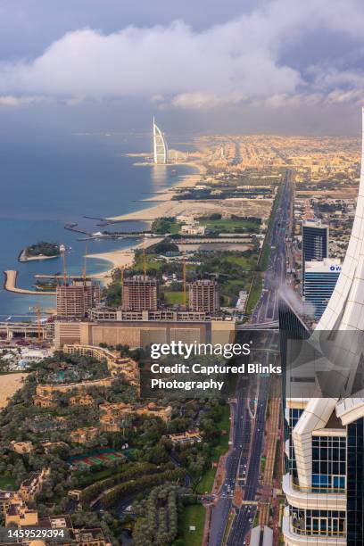 aerial view of burj al arab luxury hotel and dubai marina skyline - madinat jumeirah hotel stock pictures, royalty-free photos & images