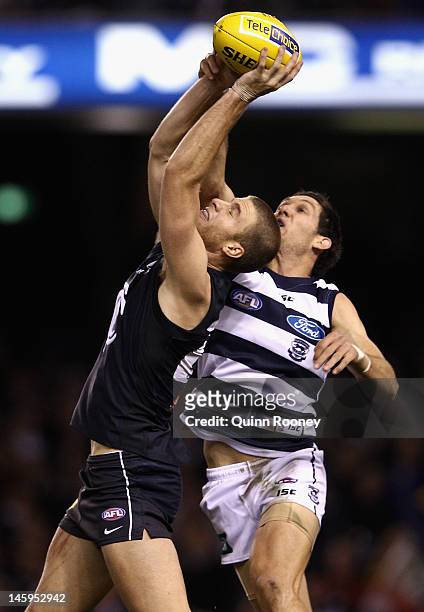 Lachie Henderson of the Blues marks infront of Harry Taylor of the Cats during the round 11 AFL match between the Carlton Blues and the Geelong Cats...