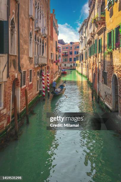 canal and traditional colourful houses in burano island, venice, burano island, italy. daytime - gondola traditional boat stockfoto's en -beelden