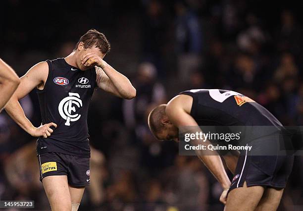 Blues players look dejected after losing the round 11 AFL match between the Carlton Blues and the Geelong Cats at Etihad Stadium on June 8, 2012 in...