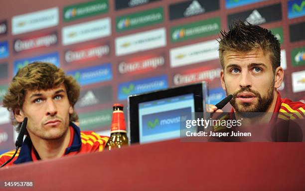 Gerard Pique of Spain answers questions from the media alongside his teammate Fernando Llorente during their joint press conference after a training...