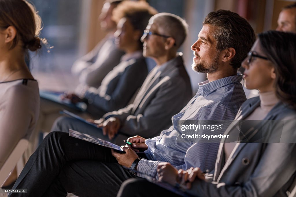 Large group of entrepreneurs attending a seminar in board room.