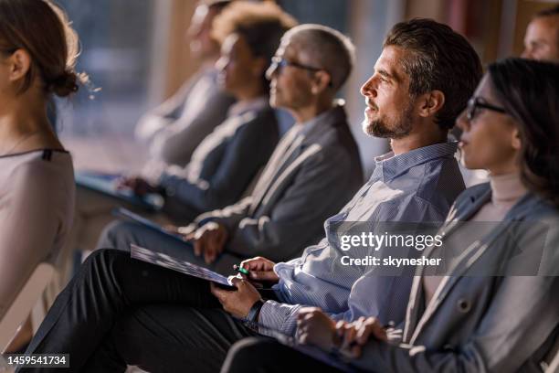 large group of entrepreneurs attending a seminar in board room. - palestra imagens e fotografias de stock