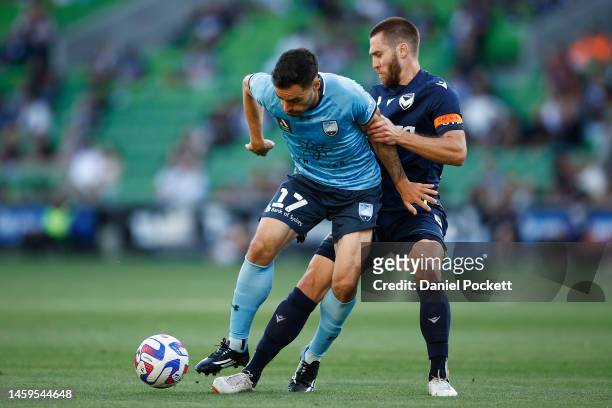 Anthony Caceres of Sydney FC and Joshua Brillante of the Victory contest the ball during the round 14 A-League Men's match between Melbourne Victory...