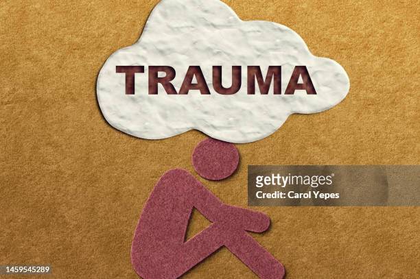 felt human representation with bubble speech showing the word trauma - cry baby cartoon stock pictures, royalty-free photos & images