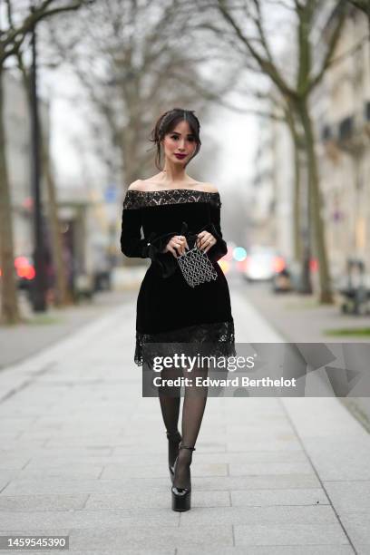 Heart Evangelista wears diamonds earrings, a black lace pattern borders shoulder-off / long sleeves velvet knees dress from Zuhair Murad, a black...