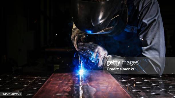 welder working in factory - welding mask stock pictures, royalty-free photos & images