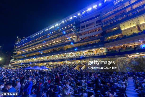 Racegoers at Happy Valley Racecourse during the LONGINES International Jockeys' Championship race night on December 7, 2022 in Hong Kong.