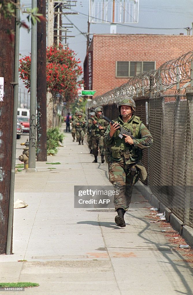 La 92 Riots National Guardsmen patrol a street, 01 May 1992 in Los Angeles. The ...