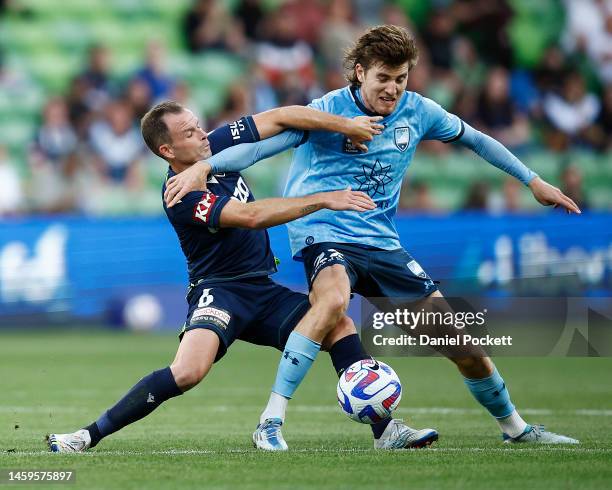 Leigh Broxham of the Victory and Max Burgess of Sydney FC contest the ball during the round 14 A-League Men's match between Melbourne Victory and...