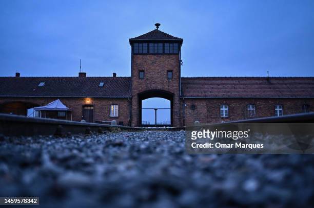 View of the main entrance and train track at the former Nazi death camp Auschwitz Birkenau on January 26, 2023 in Oswiecim, Poland. International...