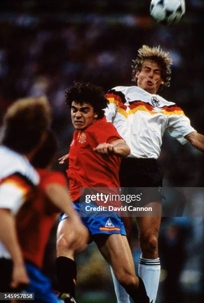 Jurgen Klinsmann of West Germany rises above Manuel Sanchis of Spain to head the ball during the UEFA European Championships 1988 Group 1 match...