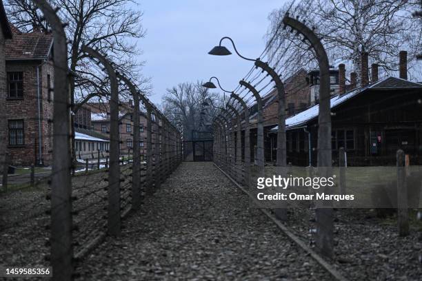 View of barbed wire fence and surveillance towers at the former Nazi death camp Auschwitz I on January 26, 2023 in Oswiecim, Poland. International...